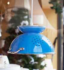 A pendant light made from a colander